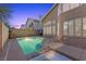 Evening view of a backyard pool featuring a spa and patio at 283 Grand Olympia Dr, Henderson, NV 89012
