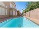 Inviting pool with jacuzzi and a whimsical pink flamingo float, perfect for relaxation and outdoor enjoyment at 283 Grand Olympia Dr, Henderson, NV 89012