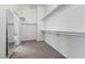 Carpeted walk-in closet with mirror and shelving at 283 Grand Olympia Dr, Henderson, NV 89012