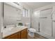 Bright bathroom with glass-enclosed shower, white tile, and wood vanity at 3425 E Russell Rd # 155, Las Vegas, NV 89120