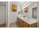 Bathroom featuring double sinks, oak cabinets, and ample lighting at 3425 E Russell Rd # 155, Las Vegas, NV 89120