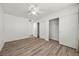 Bright bedroom features modern ceiling fan, wood-look floors, and closet at 3425 E Russell Rd # 155, Las Vegas, NV 89120