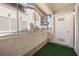 Enclosed patio with artificial turf and access to a front door at 3425 E Russell Rd # 155, Las Vegas, NV 89120