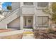 Condo with white stucco exterior and front door adorned with a wreath at 3425 E Russell Rd # 155, Las Vegas, NV 89120