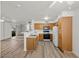 Open-concept kitchen featuring wood cabinets and modern appliances adjacent to the living area at 3425 E Russell Rd # 155, Las Vegas, NV 89120