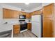 Traditional kitchen with wood cabinetry, white countertops, and modern appliances at 3425 E Russell Rd # 155, Las Vegas, NV 89120