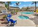 Relaxing pool area featuring a spa, seating, and mature palm trees in a gated community at 3425 E Russell Rd # 155, Las Vegas, NV 89120
