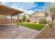 The backyard features a covered patio and artificial turf at 4512 Moon Hill Rock Ave, North Las Vegas, NV 89084