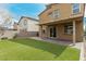 Landscaped backyard featuring artificial grass, a covered patio, and durable block wall, ideal for relaxation at 4512 Moon Hill Rock Ave, North Las Vegas, NV 89084