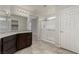 Bathroom features granite countertop, dark cabinetry, tiled flooring and glass shower at 4512 Moon Hill Rock Ave, North Las Vegas, NV 89084