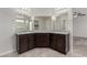 Bathroom features double vanity, granite countertop, dark cabinetry, and decorative mirrors at 4512 Moon Hill Rock Ave, North Las Vegas, NV 89084