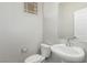 Powder bathroom featuring a pedestal sink, updated fixtures, and toilet at 4512 Moon Hill Rock Ave, North Las Vegas, NV 89084