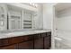 Bathroom features double vanity, granite countertop, dark cabinetry and decorative mirrors at 4512 Moon Hill Rock Ave, North Las Vegas, NV 89084