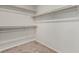 A walk-in closet features wood and white shelving and neutral carpet at 4512 Moon Hill Rock Ave, North Las Vegas, NV 89084
