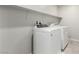 The laundry room includes white washer and dryer units and white shelving at 4512 Moon Hill Rock Ave, North Las Vegas, NV 89084
