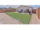 Landscaped backyard with artificial turf offers low-maintenance outdoor living and entertainment possibilities at 456 Desoto Falls St, Indian Springs, NV 89018