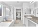 Bathroom featuring a bathtub, glass enclosed shower, and vanity with double sinks at 456 Desoto Falls St, Indian Springs, NV 89018