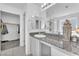 Bathroom featuring vanity with granite counters, closet and bathtub with glass shower at 456 Desoto Falls St, Indian Springs, NV 89018