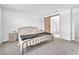 Comfortable bedroom with a metal bed frame, carpet, and ensuite bathroom with sliding barn door at 456 Desoto Falls St, Indian Springs, NV 89018