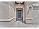 Inviting entryway with a stylish front door, decorative sign, and textured walls at 456 Desoto Falls St, Indian Springs, NV 89018