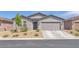 Charming single-story home featuring a two-car garage and low maintenance desert landscaping at 456 Desoto Falls St, Indian Springs, NV 89018