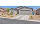 Charming single-story home with desert landscaping and a two-car garage at 456 Desoto Falls St, Indian Springs, NV 89018