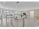 Open-concept kitchen flowing into the living area with a large island and modern finishes at 456 Desoto Falls St, Indian Springs, NV 89018