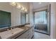 Bathroom featuring dual sinks, modern fixtures, and a glass-enclosed shower at 4916 Mount Pleasant Ln, Las Vegas, NV 89113