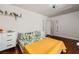 Bedroom with tropical-themed bedding, wood floors, and a window with shutters at 521 Dawn Cove Dr, Henderson, NV 89052