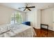 Bedroom featuring wood floors, shutters on the window, and a sliding closet at 521 Dawn Cove Dr, Henderson, NV 89052
