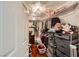 Walk-in closet with shelves, hanging rods, and wood flooring at 521 Dawn Cove Dr, Henderson, NV 89052