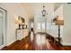 Elegant foyer featuring hardwood floors, white trim, and a decorative chandelier at 521 Dawn Cove Dr, Henderson, NV 89052