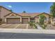 Inviting single-story home featuring a well-manicured front yard and a two-car garage at 521 Dawn Cove Dr, Henderson, NV 89052