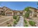 Charming single-story home with landscaped front yard and tiled walkway to the gated entrance at 521 Dawn Cove Dr, Henderson, NV 89052