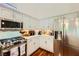 Bright kitchen with stainless steel appliances, white cabinets, and a light countertop at 521 Dawn Cove Dr, Henderson, NV 89052