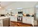 Spacious kitchen featuring stainless steel appliances, white cabinets, and hardwood floors at 521 Dawn Cove Dr, Henderson, NV 89052