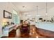 Bright kitchen and dining area with white cabinetry, hardwood floors and stainless steel appliances at 521 Dawn Cove Dr, Henderson, NV 89052