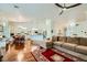 Bright, open-concept living room featuring hardwood floors, ceiling fan, and seamless flow into the modern kitchen at 521 Dawn Cove Dr, Henderson, NV 89052