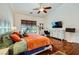 Comfortable main bedroom with a ceiling fan, window, and decorative guitars on the wall at 521 Dawn Cove Dr, Henderson, NV 89052