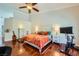 Bedroom featuring a ceiling fan, neutral walls, wood floors, and an exercise bike at 521 Dawn Cove Dr, Henderson, NV 89052