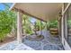 Charming covered patio with a decorative fountain, lush landscaping, and elegant tiled flooring at 521 Dawn Cove Dr, Henderson, NV 89052