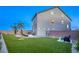 Inviting backyard featuring lush artificial grass, a seating area, and secure fencing for outdoor enjoyment at 5368 Knitmore Ct, Las Vegas, NV 89139