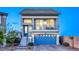 Charming two-story home with a blue door, balcony, a two-car garage and landscaped front yard at 5368 Knitmore Ct, Las Vegas, NV 89139