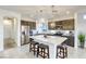 Modern kitchen features a large island, stainless steel appliances, and dark cabinetry for a sleek design at 5368 Knitmore Ct, Las Vegas, NV 89139