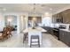 Spacious kitchen with stainless steel appliances, center island with seating, and adjacent dining area at 5368 Knitmore Ct, Las Vegas, NV 89139