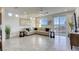 Bright living room with tile floors, large windows, a ceiling fan, and a comfortable sectional sofa at 5368 Knitmore Ct, Las Vegas, NV 89139