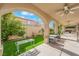 Charming backyard patio has ceiling fans and has a grass yard, bench and seating at 9155 Bush Poppy Ave, Las Vegas, NV 89147