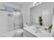 Clean bathroom with a shower-tub combo and glass door at 9155 Bush Poppy Ave, Las Vegas, NV 89147