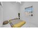 Simple bedroom features neutral tones, natural light, and minimalist decor at 9155 Bush Poppy Ave, Las Vegas, NV 89147