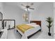 Cozy bedroom with plush bedding, a ceiling fan, and bright natural light at 9155 Bush Poppy Ave, Las Vegas, NV 89147